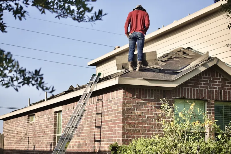 Professional roofer working on a residential roof in Grandview Grove